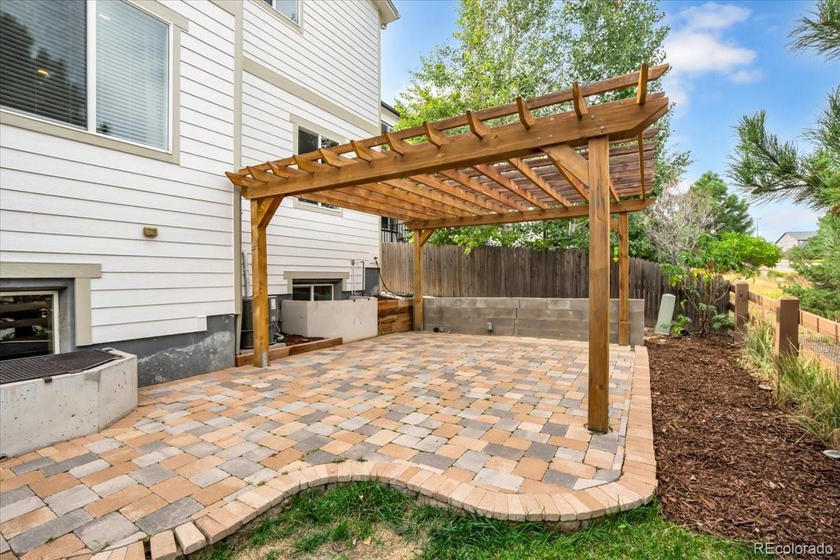 1767 Ghost Dance Circle Castle Rock, CO 80108 - Photo 42 of 48 a patio with table and chairs and potted plants