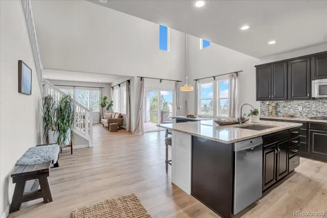 a bathroom with a granite countertop sink and a toilet