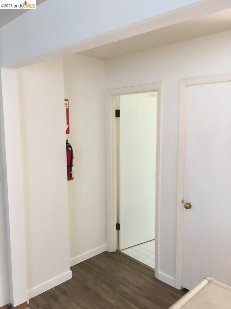 1641 Walnut Street Berkeley, CA 94709 - Photo 8 of 11 corridor with dark wood-style flooring and baseboards