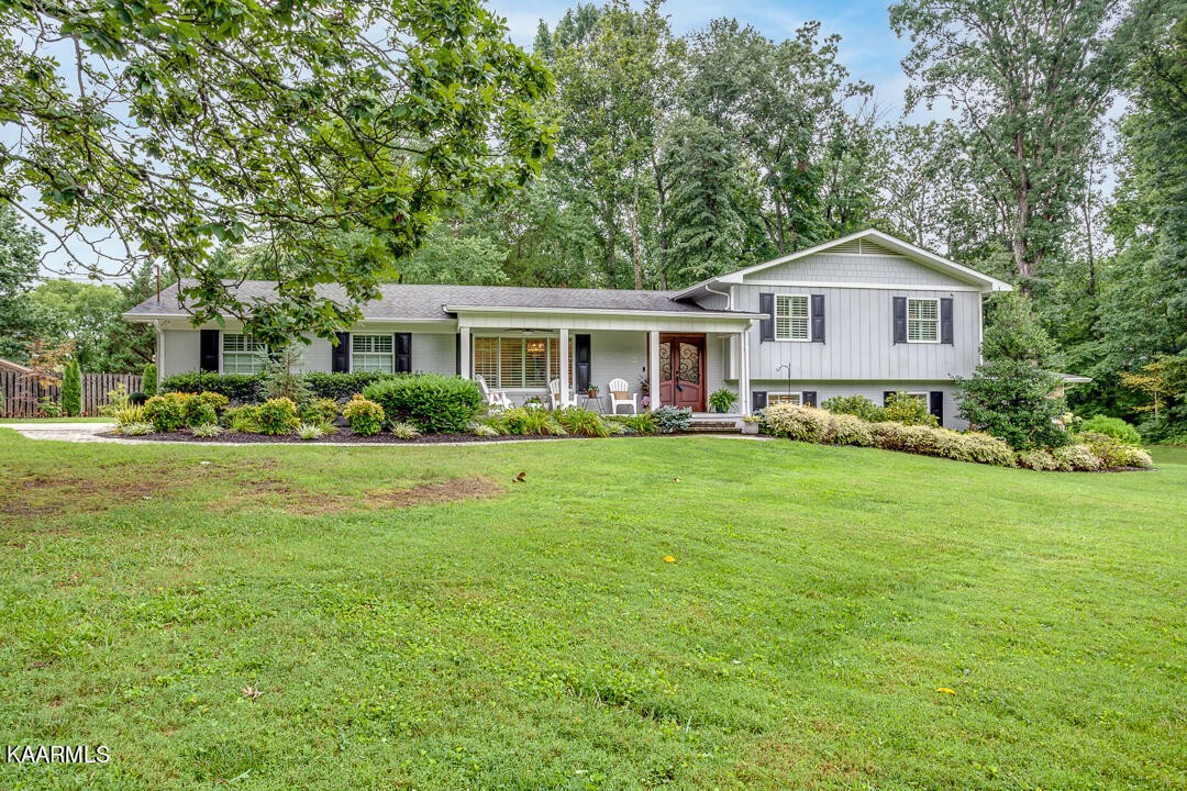 433 Smith Road Knoxville, TN 37934 - Photo 2 of 42 a front view of a house with a garden and trees