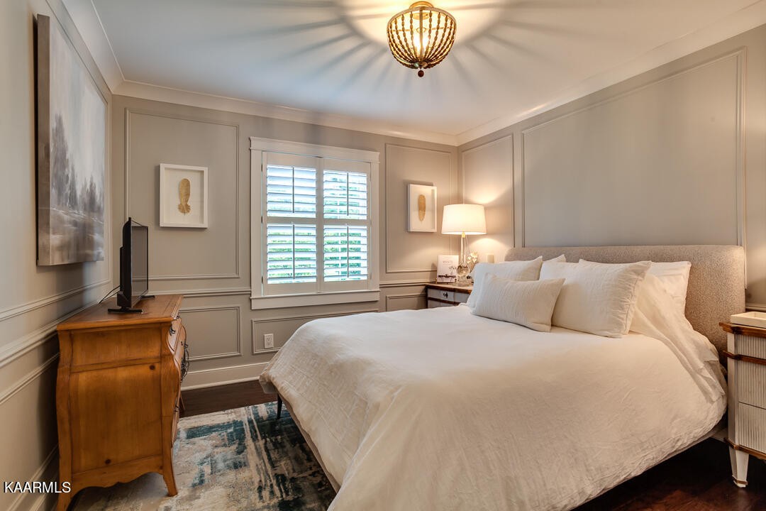 433 Smith Road Knoxville, TN 37934 - Photo 27 of 42 a bedroom with a bed and a chandelier
