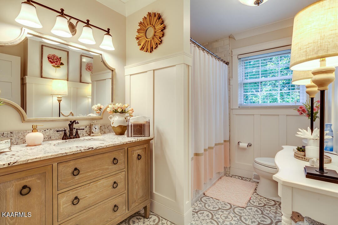 433 Smith Road Knoxville, TN 37934 - Photo 29 of 42 a bathroom with a granite countertop sink toilet and shower