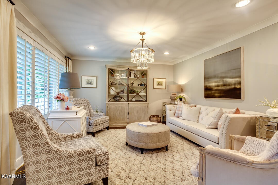 433 Smith Road Knoxville, TN 37934 - Photo 7 of 42 a living room with furniture a chandelier and a fireplace