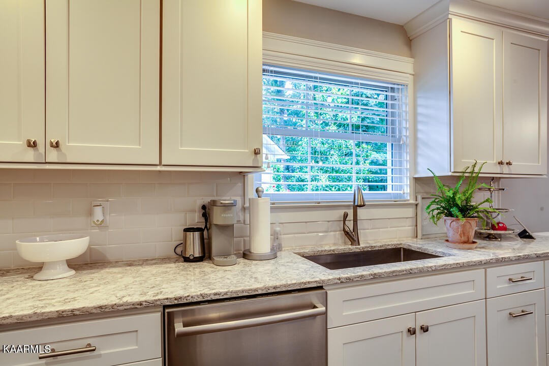 433 Smith Road Knoxville, TN 37934 - Photo 10 of 42 a kitchen with stainless steel appliances granite countertop a sink and a window
