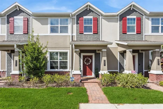 front view of a brick house with a yard