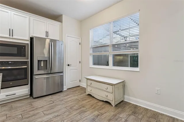 a view of hallway with sink and wooden floor