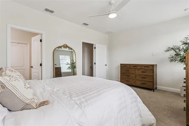 a bedroom with a bed a lamp and a window