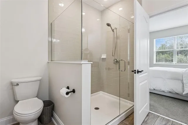 a bathroom with a granite countertop sink a toilet and a mirror
