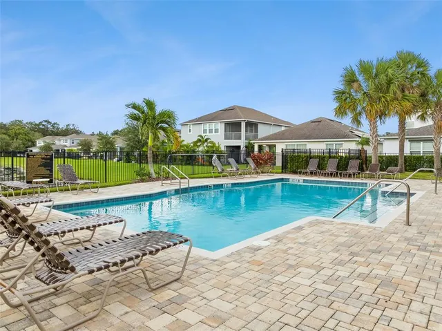 an aerial view of residential houses with outdoor space and street view