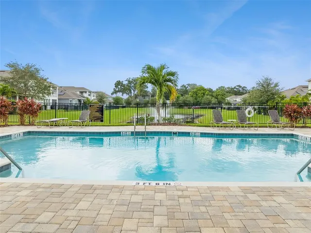 a view of swimming pool with a lawn chairs