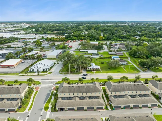 a front view of a building with garden and patio