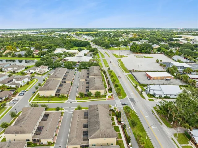 a view of a house with patio furniture and garden