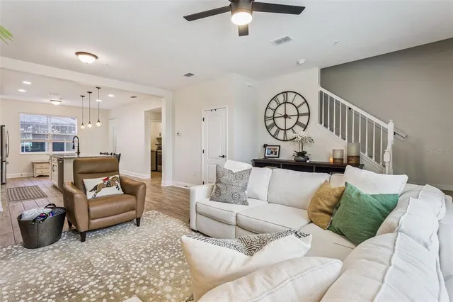 a kitchen with stainless steel appliances kitchen island granite countertop a stove a sink a refrigerator and a cabinets