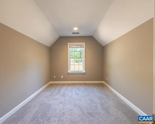 a spacious bathroom with a granite countertop sink a toilet and a mirror