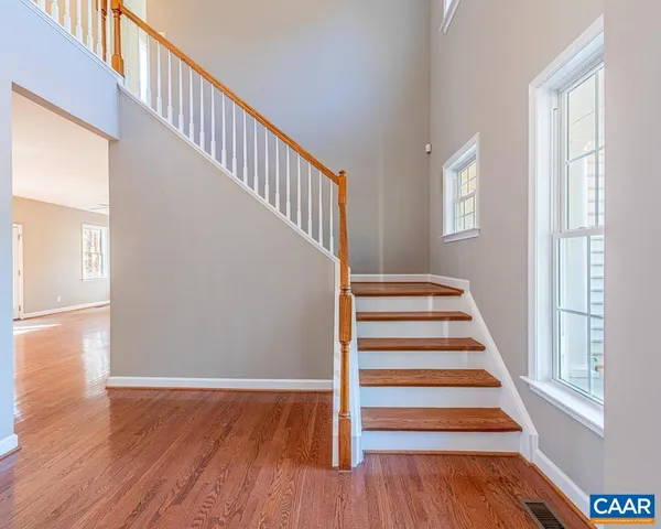 a view of entryway and hall with wooden floor