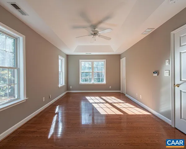 a spacious bathroom with a tub sink and mirror