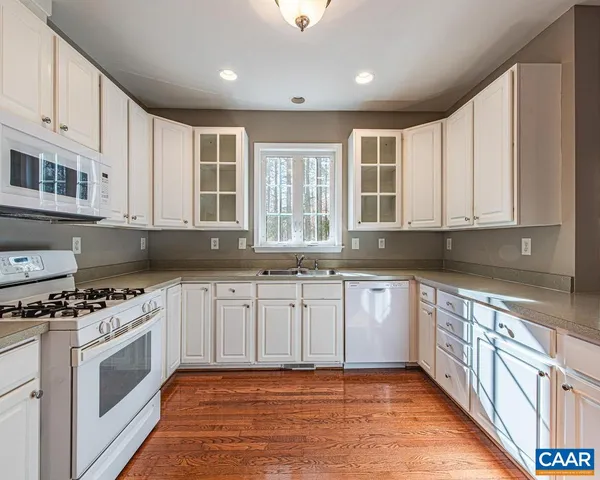 a kitchen with stainless steel appliances granite countertop a stove and a sink