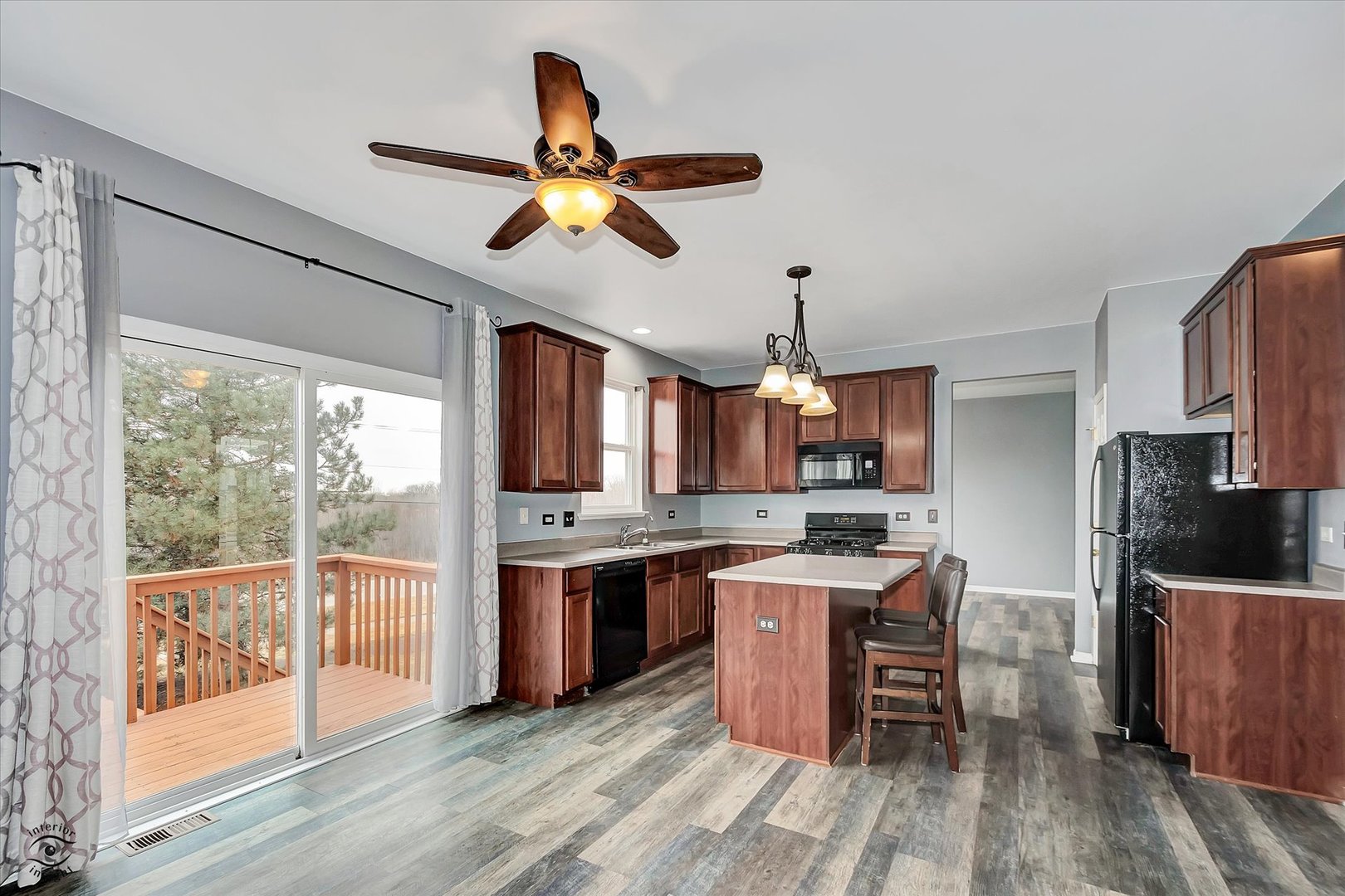 17840 Sorrel Drive Lockport, IL 60441 - Photo 11 of 27 a kitchen with stainless steel appliances granite countertop a stove top oven a sink dishwasher a dining table and chairs with wooden floor