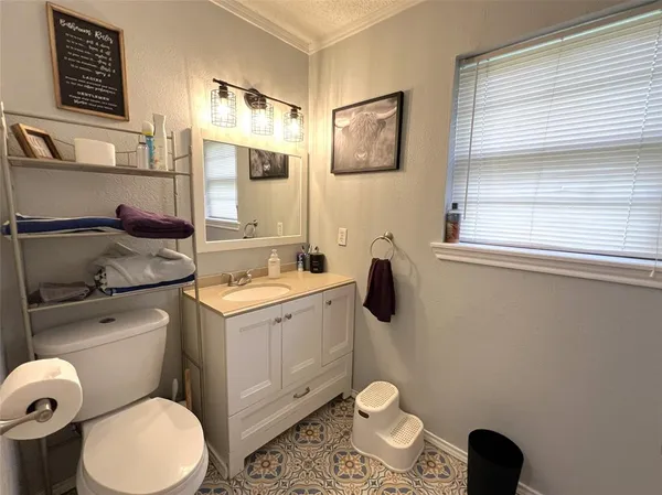 a bathroom with a sink toilet and mirror