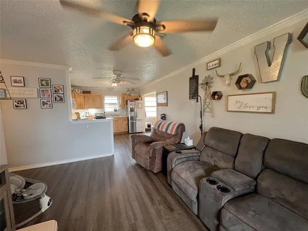 a living room with furniture and kitchen view