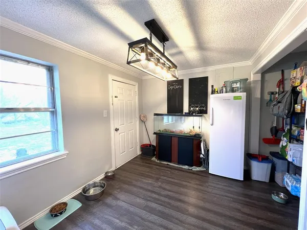 a kitchen with stainless steel appliances granite countertop a refrigerator a sink dishwasher a stove and white countertops with wooden floor