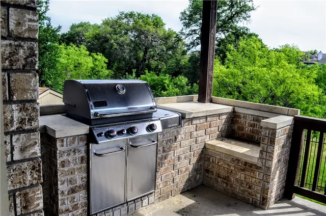 a view of a patio with table and chairs