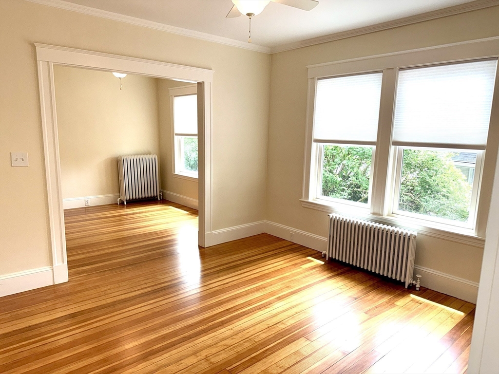39 Newman Road Malden, MA 02148 - Photo 4 of 27 a view of an empty room with wooden floor and a window