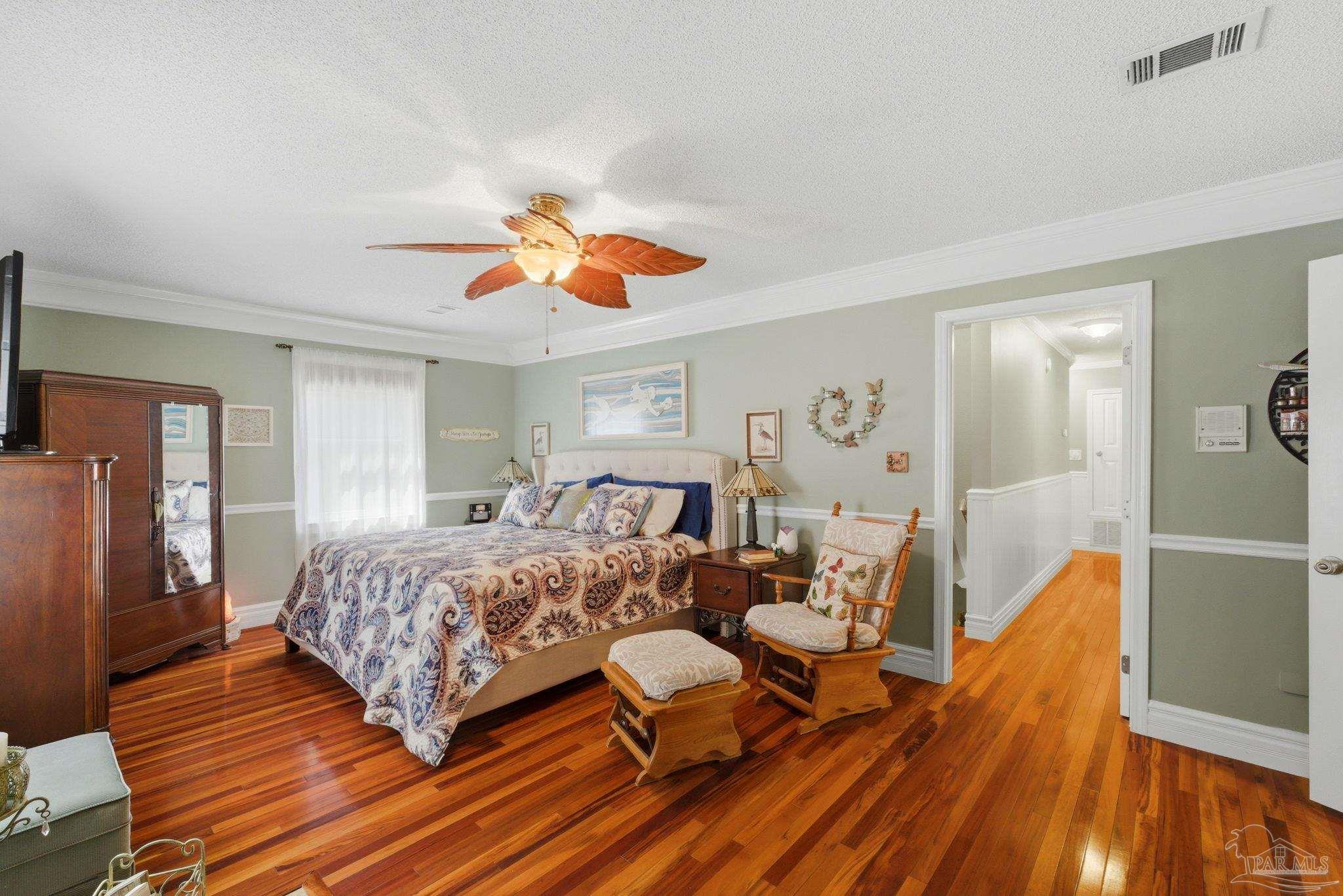 6930 Summit Way Milton, FL 32570 - Photo 28 of 71 a bedroom with a bed and wooden floor