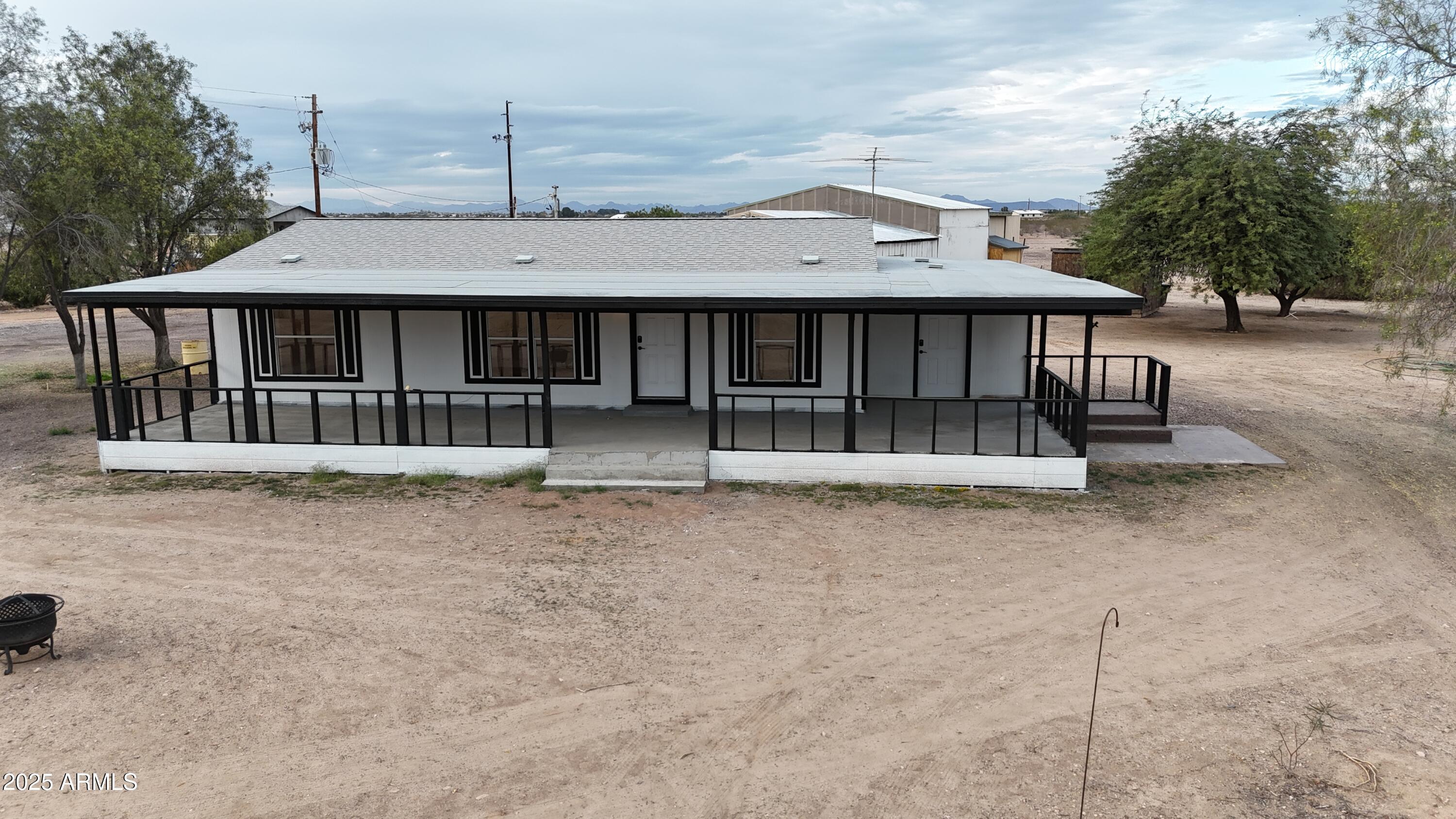 34040 West Lower Buckeye Road Tonopah, AZ 85354 - Photo 12 of 45 a front view of a house with a yard