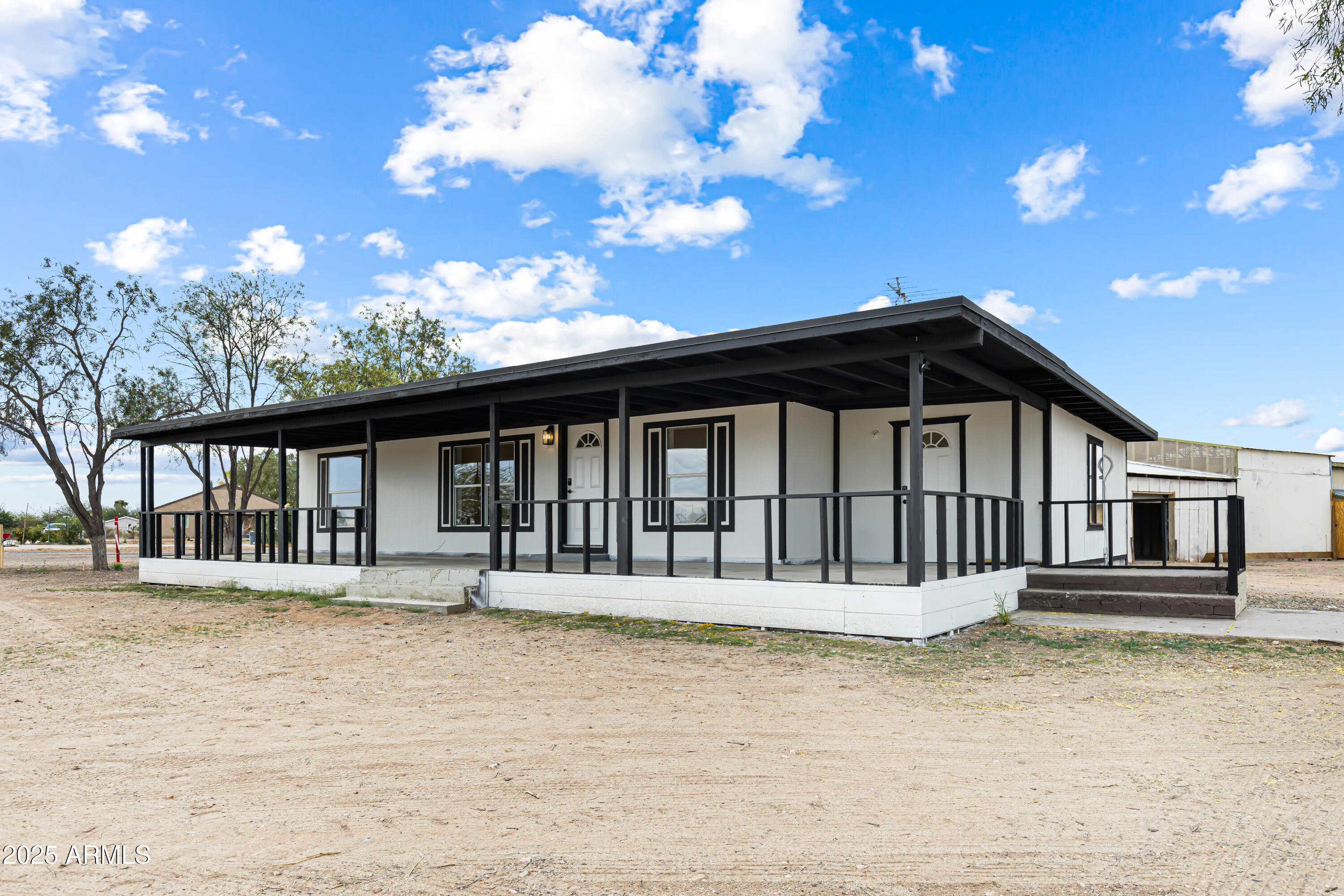 34040 West Lower Buckeye Road Tonopah, AZ 85354 - Photo 13 of 45 a front view of a house with a yard