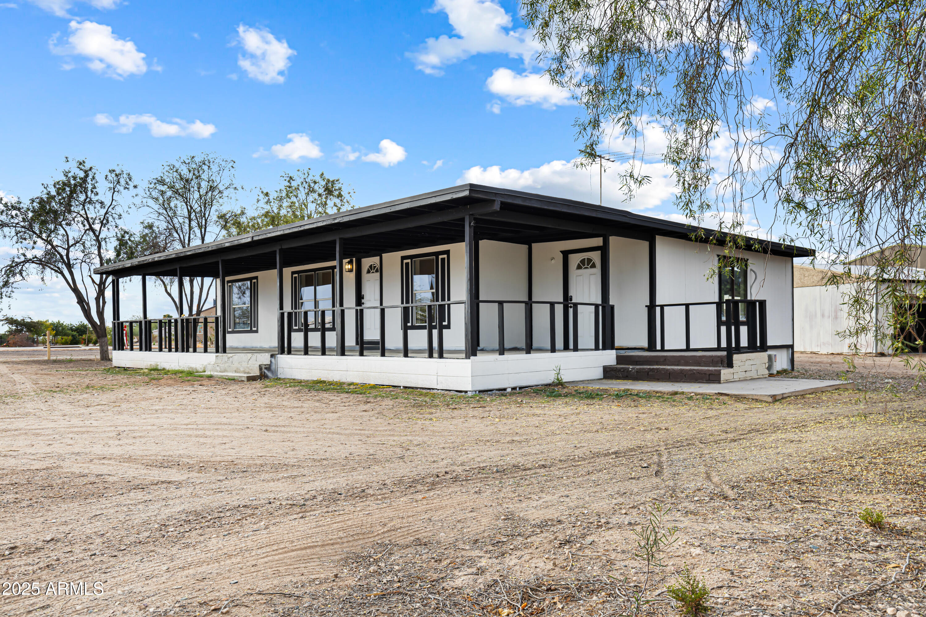 34040 West Lower Buckeye Road Tonopah, AZ 85354 - Photo 14 of 45 a view of a house with a swimming pool and a yard