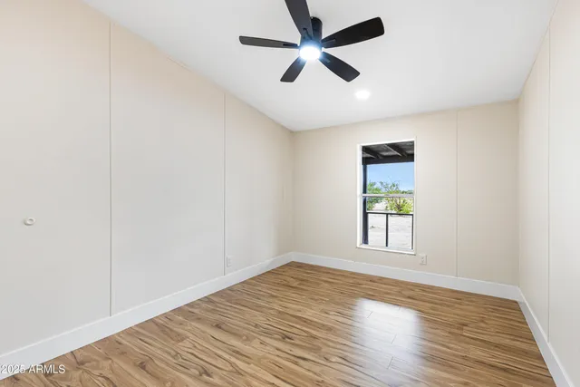 wooden floor in an empty room with a window