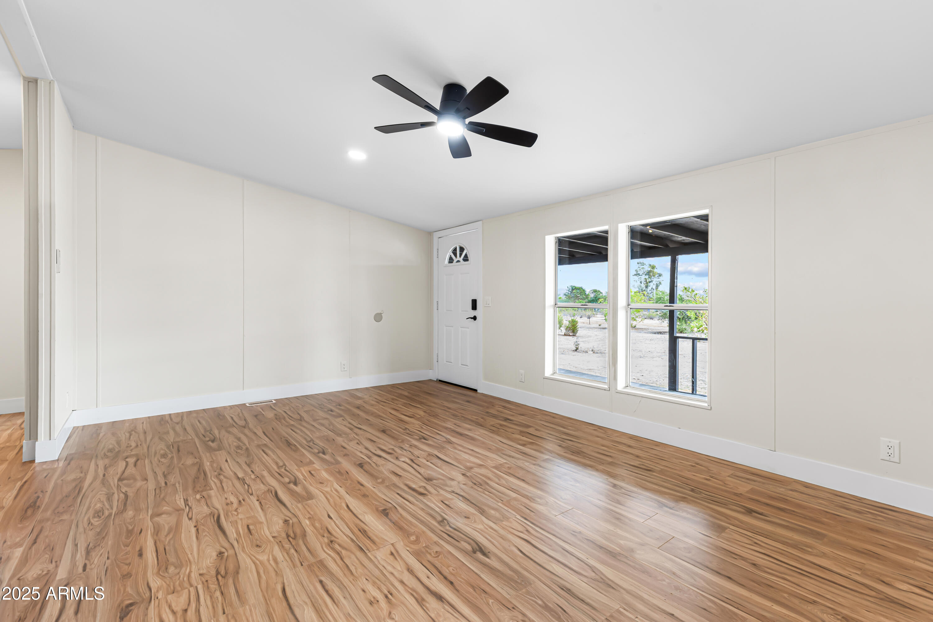 34040 West Lower Buckeye Road Tonopah, AZ 85354 - Photo 22 of 45 a view of empty room with wooden floor and fan
