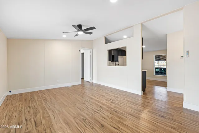 wooden floor in an empty room with a window