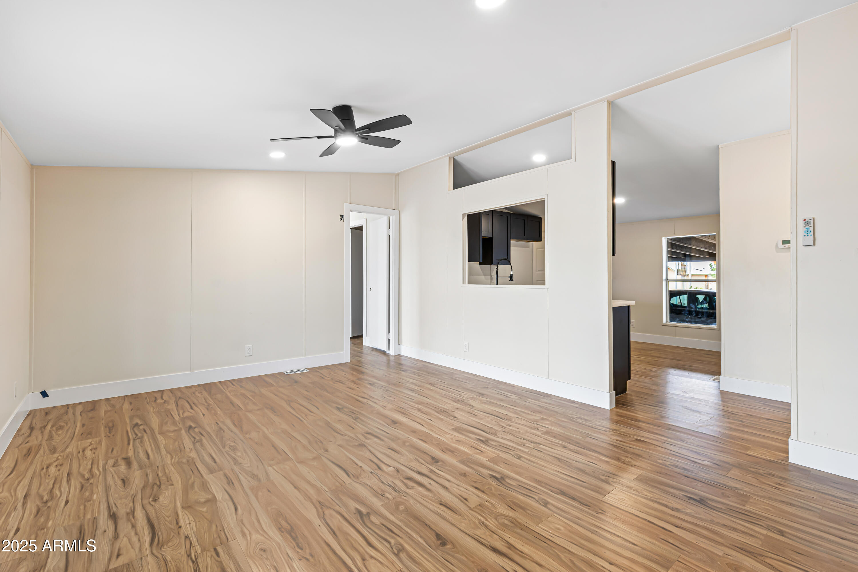34040 West Lower Buckeye Road Tonopah, AZ 85354 - Photo 23 of 45 wooden floor in an empty room with a window
