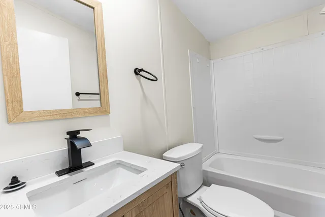 a bathroom with a sink a toilet and a tub