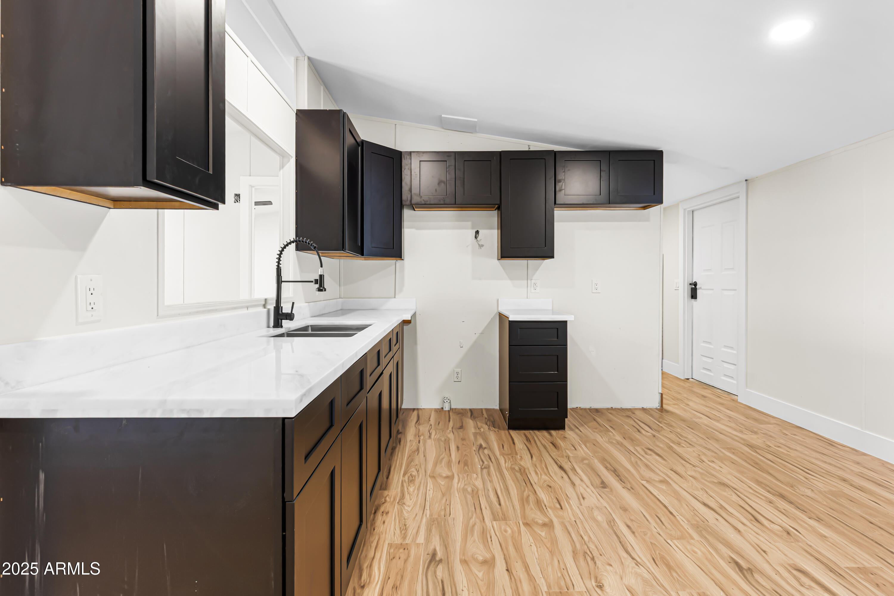 34040 West Lower Buckeye Road Tonopah, AZ 85354 - Photo 26 of 45 a kitchen with stainless steel appliances granite countertop a sink and a refrigerator