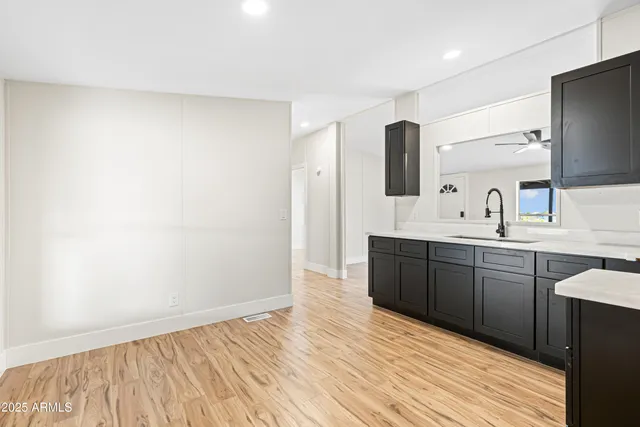 a spacious bathroom with a double vanity sink and mirror