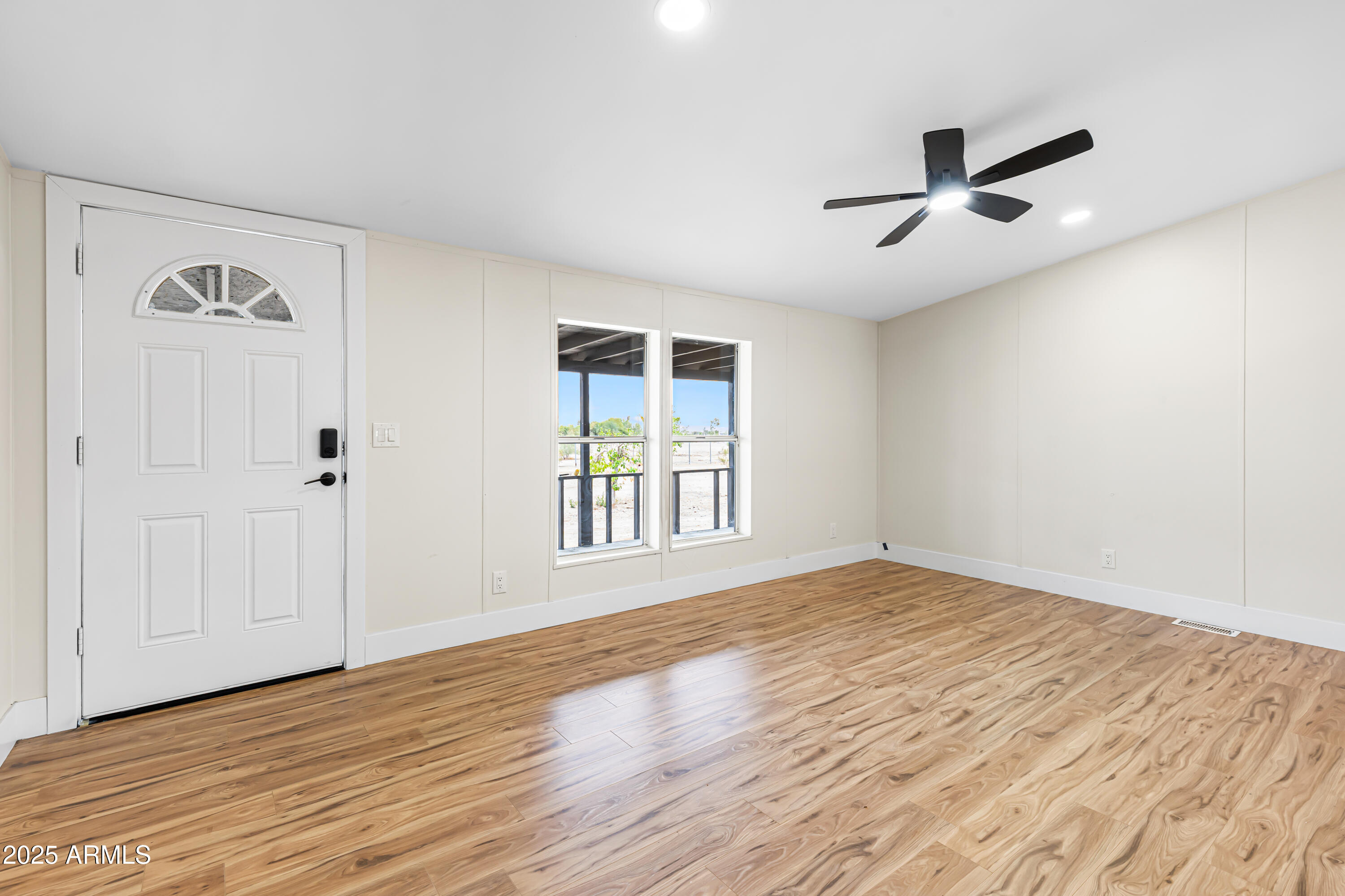34040 West Lower Buckeye Road Tonopah, AZ 85354 - Photo 28 of 45 a view of empty room with wooden floor and fan