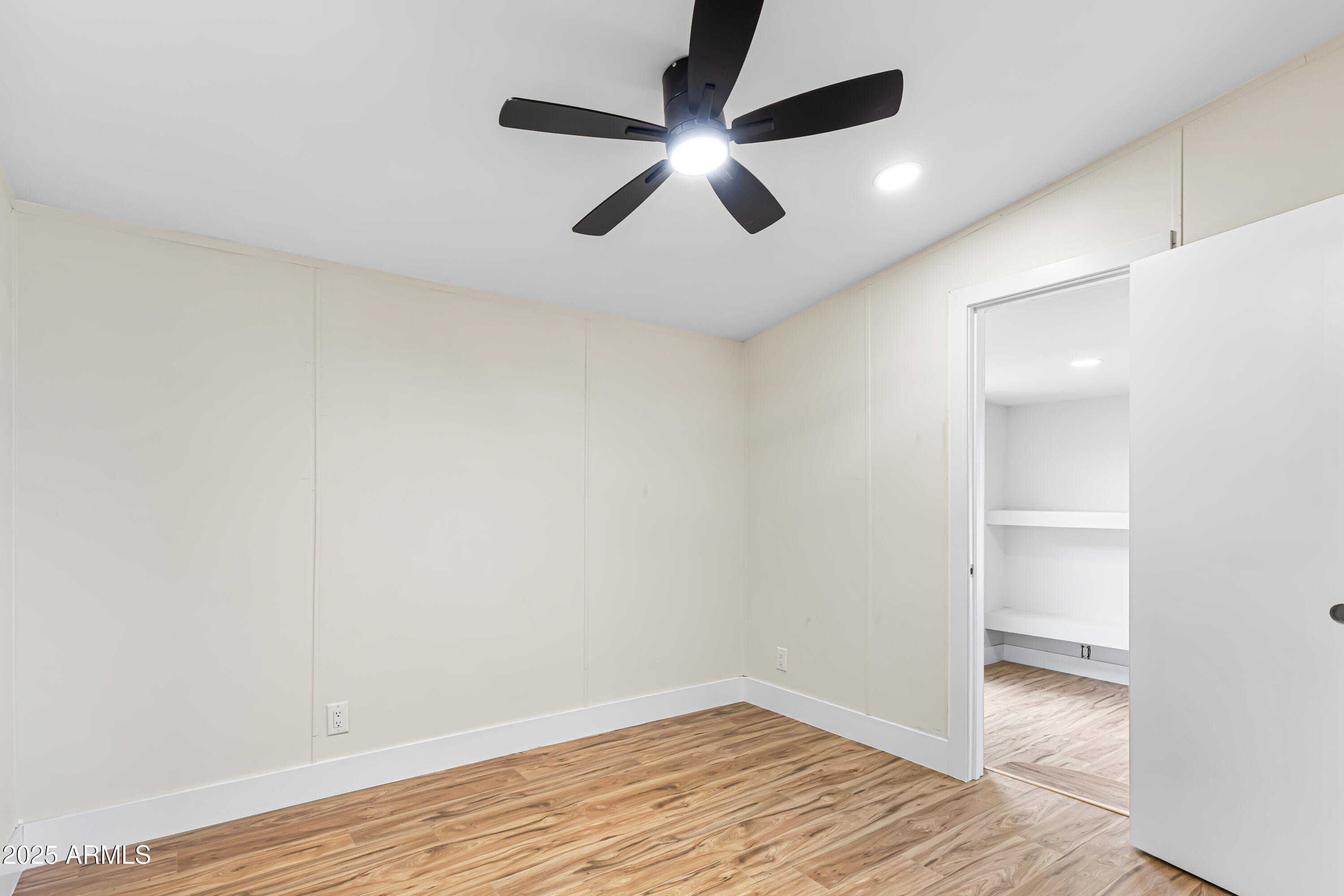 34040 West Lower Buckeye Road Tonopah, AZ 85354 - Photo 29 of 45 a view of an empty room with wooden floor