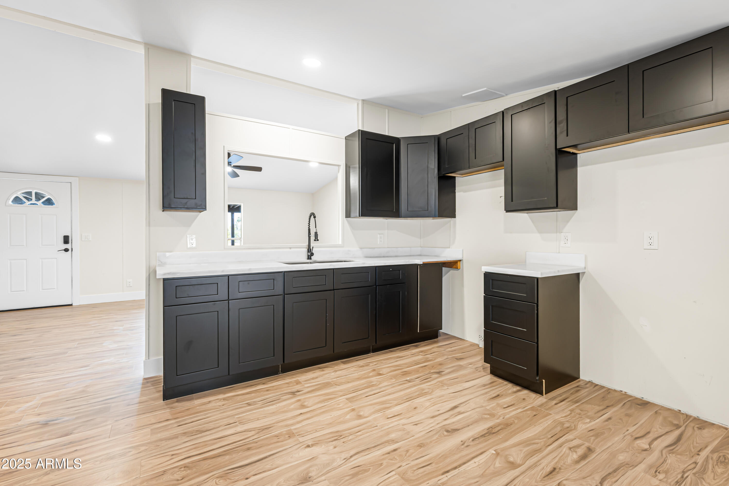 34040 West Lower Buckeye Road Tonopah, AZ 85354 - Photo 37 of 45 a kitchen with a refrigerator and a sink
