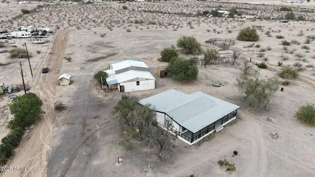 an aerial view of a house with a yard