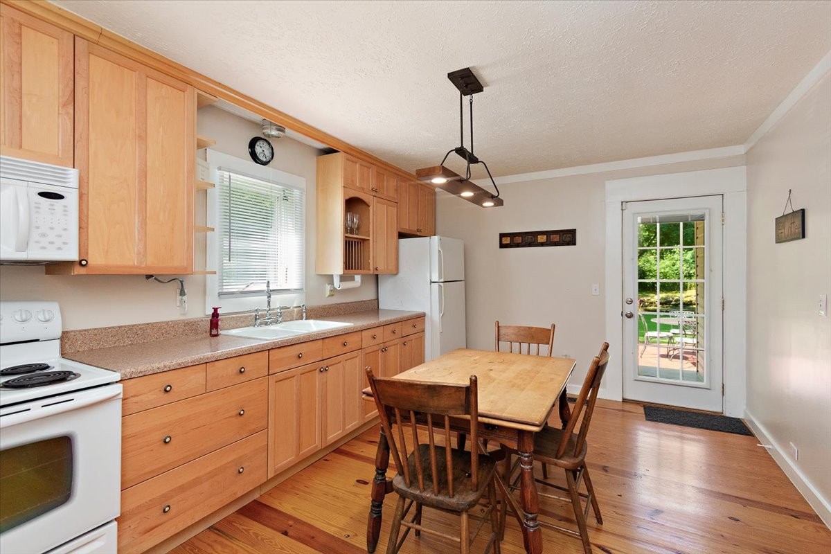 1570 Wolf Creek Road Silver Point, TN 38582 - Photo 11 of 40 a view of a kitchen area with furniture and wooden floor