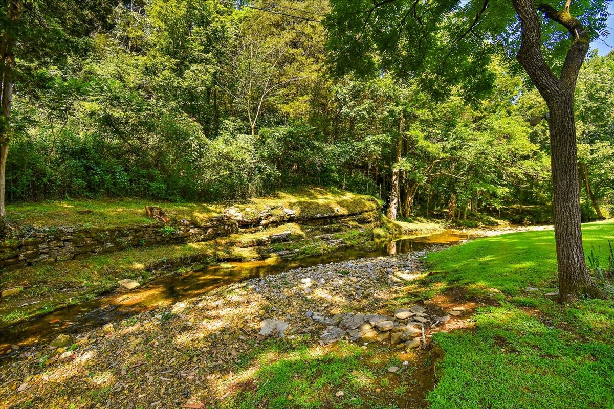 1570 Wolf Creek Road Silver Point, TN 38582 - Photo 32 of 40 a backyard of a house with a yard and outdoor seating