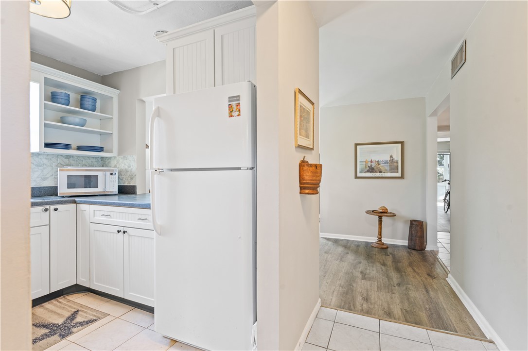 275 Date Palm Road, Unit 307 Vero Beach, FL 32963 - Photo 8 of 36 a white refrigerator freezer sitting inside of a kitchen