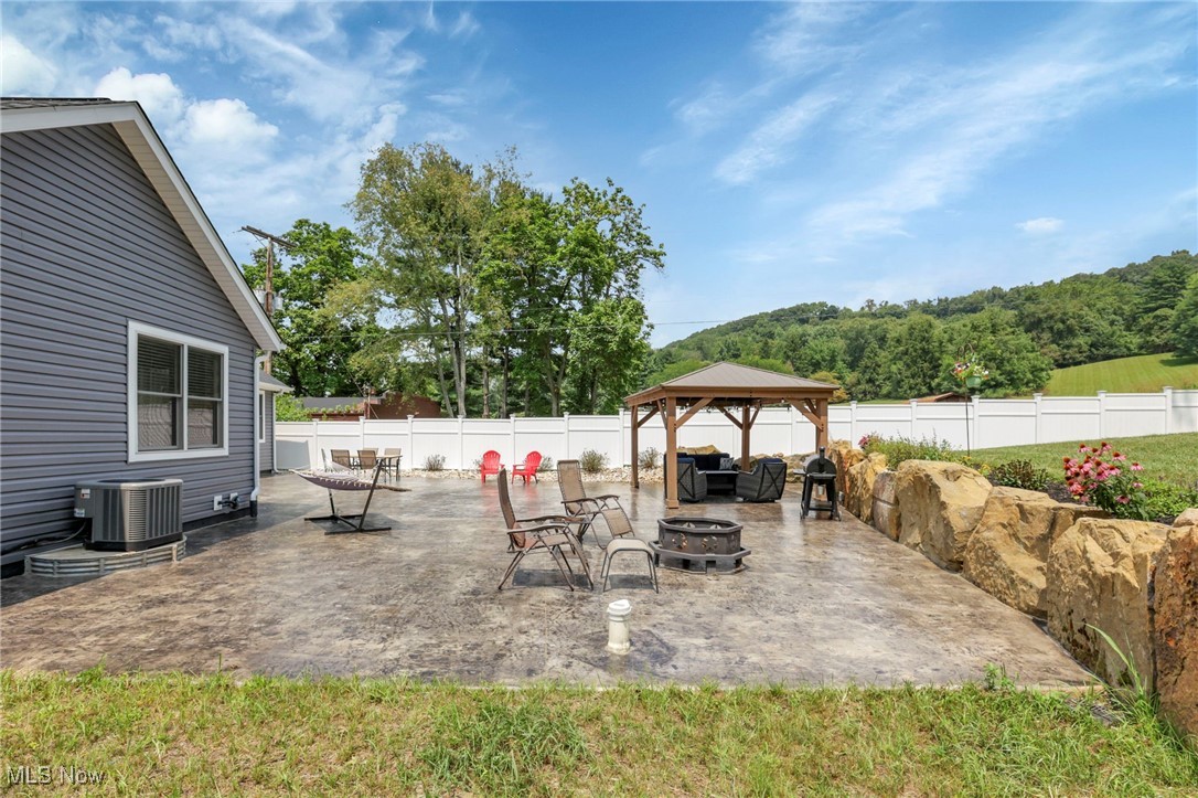 1890 Baltimore Road Northwest Lancaster, OH 43130 - Photo 39 of 50 View of patio featuring a gazebo, central AC unit, and an outdoor fire pit