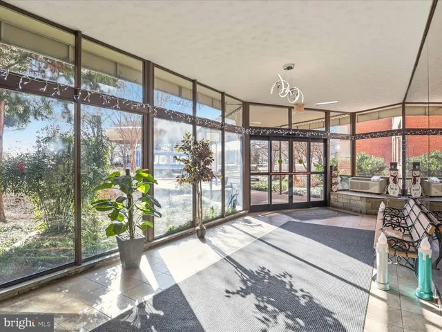 a spacious bedroom with a large window and a table