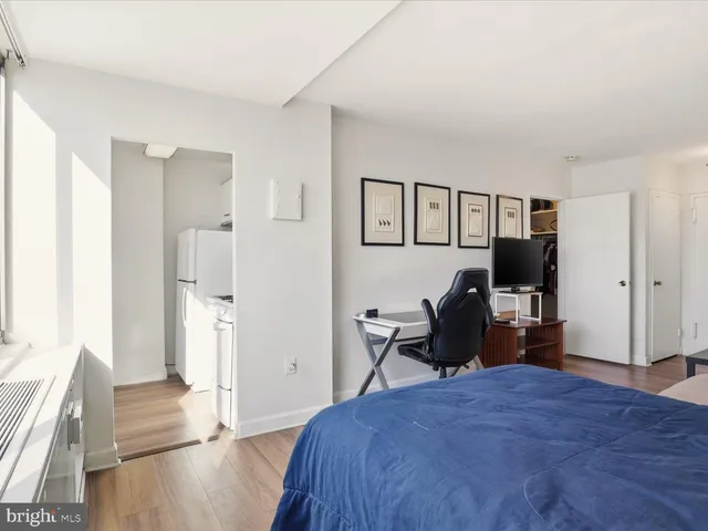 a bedroom with a bed and wooden floor
