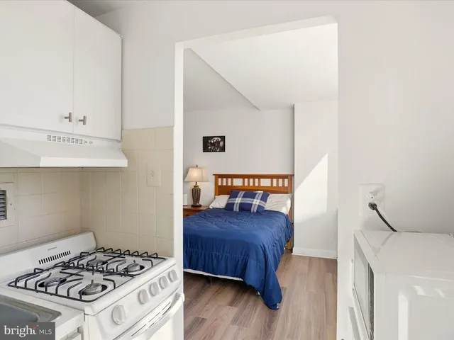 a bedroom with a bed and a dresser in it