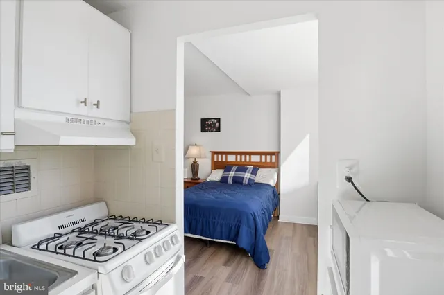 a bedroom with a bed and a dresser in it